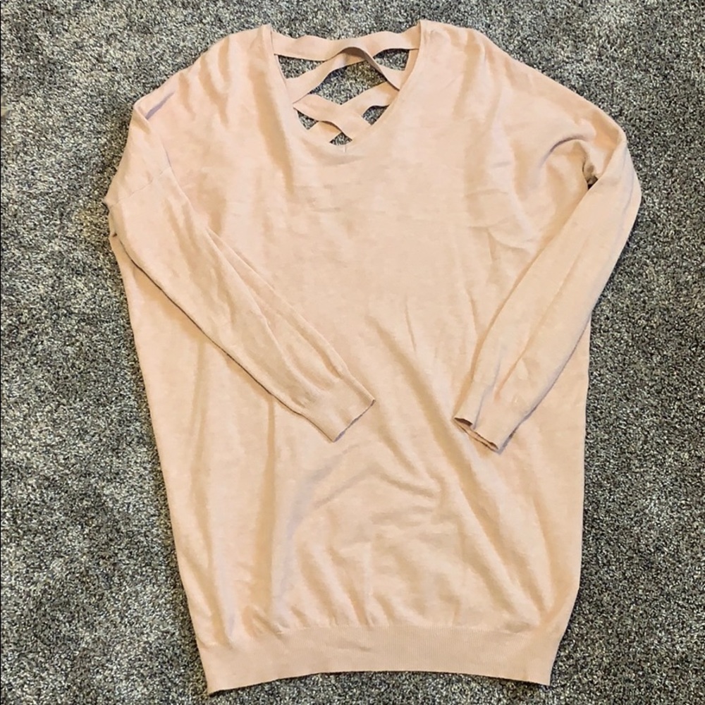 Light pink tunic sweater. Crosses in back